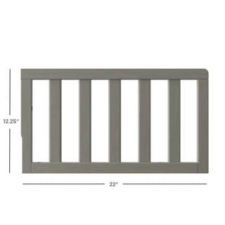The Child Craft F09501 Toddler Guard Rail in Lunar Gray features strong wood construction, vertical slats, and measures 12.25"H x 22"W—offering a simple, safe design ideal for crib-to-toddler bed conversions.