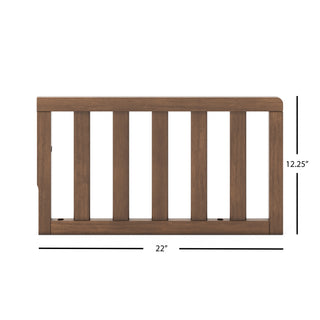 The Child Craft F09501 Toddler Guard Rail in Cocoa Bean features a dark brown finish, measures 22" wide by 12.25" tall, and is designed with vertical slats and a flat top for crib conversion; fits select Child Craft cribs.