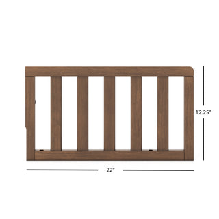 The Child Craft F09501 Toddler Guard Rail in Cocoa Bean features a dark brown finish, measures 22" wide by 12.25" tall, and is designed with vertical slats and a flat top for crib conversion; fits select Child Craft cribs.