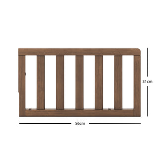 The Child Craft F09501 - Toddler Guard Rail in Cocoa Bean features a wooden panel with vertical slats, measuring 56 cm wide by 31 cm tall, shown against a white background with labeled measurements. Perfect for crib conversion.