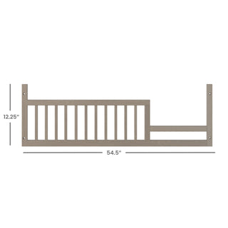 The Child Craft F09503 Toddler Guard Rail in Crescent Grey measures 54.5"W x 12.25"H, features vertical slats and mounting holes for easy crib conversion, and is designed for use with Child Craft cribs.