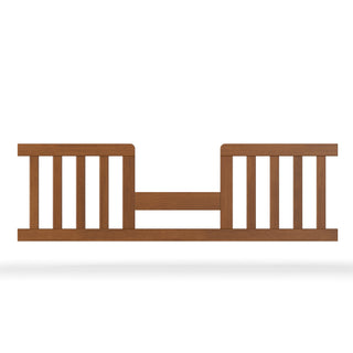 The Child Craft F09514 Toddler Guard Rail in Coach Cherry features vertical slats and an open center, attaching to the side of a crib toddler bed to enhance safety and security.