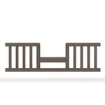 The Child Craft F09514 Toddler Guard Rail in Dapper Grey features vertical slats, an open center with a horizontal support bar, and is designed for easy crib-to-toddler bed conversion while providing added safety for your child.