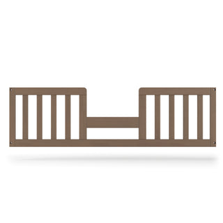 The Child Craft F09514 Toddler Guard Rail in Dusty Heather features sturdy wood construction with vertical slats and a low, open center, securely attaching to prevent falls during toddler bed conversion.