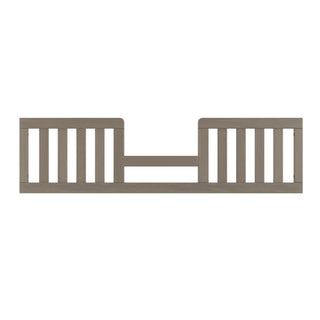 Straight-on view of the Child Craft Toddler Guard Rail in Crescent Grey, designed with vertical slats to securely fit along a child's bed side and provide added safety.