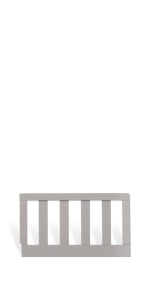 The Child Craft Toddler Guard Rail in Cool Gray features vertical wooden slats and is displayed against a white background.
