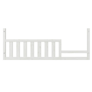 The Child Craft Toddler Guard Rail in White/Brown features vertical slats and an uneven top edge, easily attaching to a toddler bed or crib conversion to add extra safety for your child.