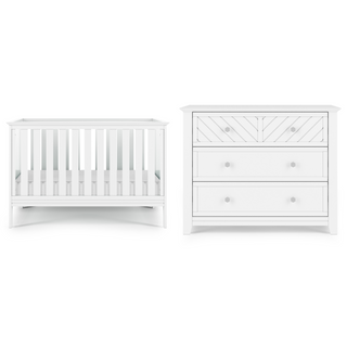 The Child Craft Atwood 3-in-1 Euro Convertible Crib in Matte White stands beside a matching three-drawer dresser with round knobs and a chevron-patterned top drawer.