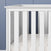 A close-up of the Child Craft Atwood 3-in-1 Euro Convertible Crib in Matte White, featuring vertical slats and a subtly patterned mattress sheet, set against a blue-paneled wall.