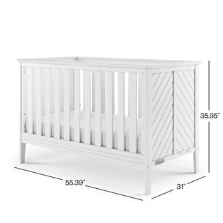 The Child Craft Atwood 3-in-1 Euro Convertible Crib in Matte White features vertical slats, diagonal panel ends, and measures 55.39"L x 31"W x 35.95"H. Shown with an empty crib and mattress.