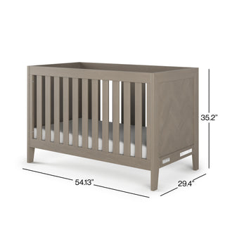 The Child Craft Kieran 3-in-1 Convertible Crib in Crescent Gray features vertical slats on all sides and measures 54.13"W x 29.4"D x 35.2"H.