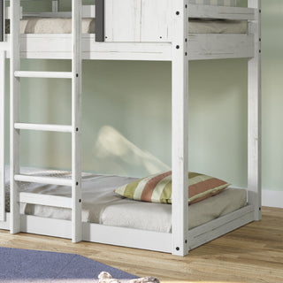 The Child Craft Modern Farmhouse Twin Over Twin Bunk Bed in white/black features a white wooden frame, gray mattress, striped pillows, and a ladder to the top bunk, positioned on a wooden floor beside a light green wall.