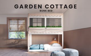 A cozy kids’ room highlights the Child Craft Garden Cottage Twin over Twin Bunk Bed, featuring charming window shutters and green faux plants. The Montessori-style bottom bunk sits on the floor, creating a whimsical, sunlit space.