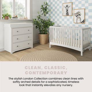 A modern nursery features a white crib, the Child Craft Harmony 3-Drawer Dresser with Changing Table Topper in matte white, potted plants, cute animal wall art, a light wooden floor, a round woven rug, and a blue-checkered accent wall for a clean look.