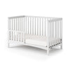 The Child Craft F09501 Toddler Guard Rail in Matte White features sturdy wood construction and vertical slats, shown with a white mattress against a plain white background.