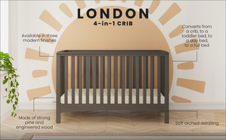 The Child Craft London 4-in-1 Convertible Crib in Dapper Gray features modern finishes, durable wood, and soft arched details. Shown on a herringbone floor with a polka dot mattress against a sunburst wall, it offers versatile convertible functionality.