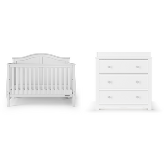 A Child Craft Camden 4-in-1 Convertible Crib in matte white with vertical slats stands beside a matching white three-drawer dresser, both featuring a classic design and round knobs, set against a plain backdrop.