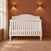 Child Craft Camden 4-in-1 Convertible Crib in matte white with an arched headboard.