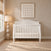 Child Craft Camden 4-in-1 Convertible Crib in matte white with a curved headboard.