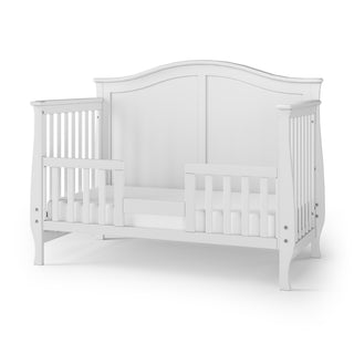 The Child Craft Camden 4-in-1 Convertible Crib in matte white features a curved headboard, open slats, low front rail, and sits on four short legs. Mattress and bedding not included.