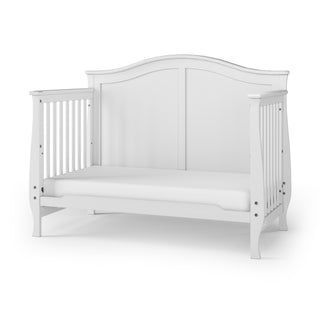 The Child Craft Camden 4-in-1 Convertible Crib in matte white features an arched back panel and slatted sides, offering versatile nursery furniture with a stylish design.