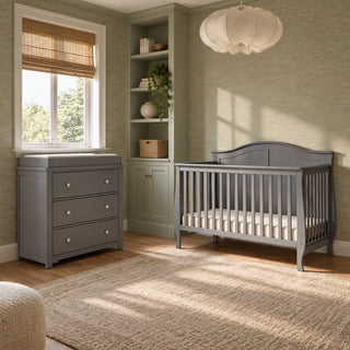 Child Craft Camden 2-Piece Nursery Set With Crib and Dresser in dark grey, featuring a convertible crib with an arched headboard and a matching 3-drawer dresser with a changing table topper.