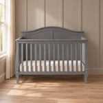 Child Craft Camden 4-in-1 Convertible Crib in Cool Grey with a curved headboard and vertical slats.
