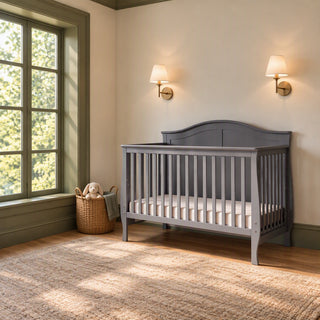 Child Craft Camden 4-in-1 Convertible Crib in cool grey with a curved headboard.