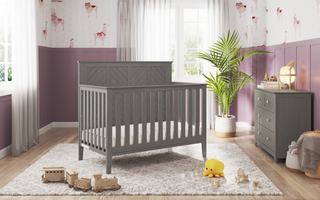 The Child Craft Atwood 3-Drawer Dresser in Lunar Gray is placed in the room.