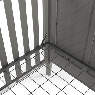 Close-up of a metal mattress support frame attached to the corner of the Child Craft Atwood 4-in-1 Convertible Crib in Lunar Gray, featuring vertical wooden slats.