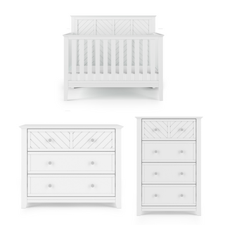 The set includes the Child Craft Atwood 4-in-1 Convertible Crib in Matte White with vertical slats and chevron panels, a matching three-drawer dresser, and a tall chest of drawers with coordinating chevron detailing.