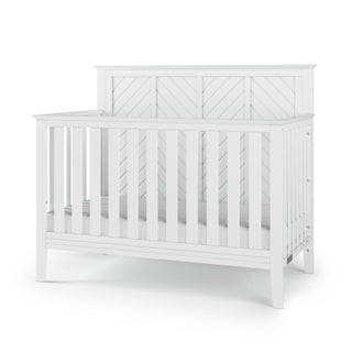 The Child Craft Atwood 4-in-1 Convertible Crib in Matte White features slatted sides and a solid decorative headboard panel, shown on a white background.