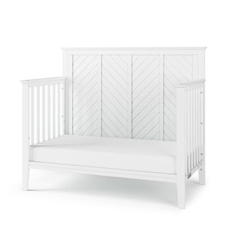 The Child Craft Atwood 4-in-1 Convertible Crib in Matte White features a matching white bed rail.