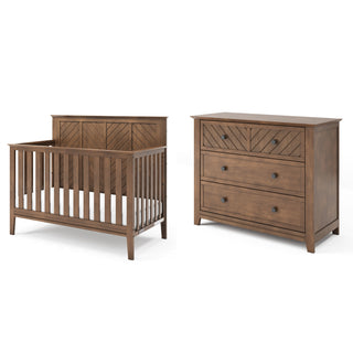 The Child Craft Atwood 4-in-1 Convertible Crib in Cocoa Bean and matching three-drawer dresser feature a brown finish and chevron pattern on the crib headboard and dresser’s top drawer.