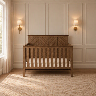 Cocoa Bean Child Craft Atwood 4-in-1 Convertible Crib in brown wood featuring a chevron pattern on the headboard.
