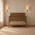 Cocoa Bean Child Craft Atwood 4-in-1 Convertible Crib in brown wood featuring a chevron pattern on the headboard.