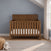 Child Craft Atwood 4-in-1 Convertible Crib in Cocoa Bean, a wooden crib featuring a chevron pattern on the headboard and baby-safe finishes.