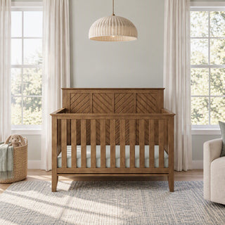 Child Craft Atwood 4-in-1 Convertible Crib in Cocoa Bean with a herringbone-patterned headboard, vertical slatted sides, and baby-safe finishes.