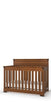 The Child Craft Redmond 4-in-1 Convertible Crib in Coach Cherry features vertical slats, a high headboard, and a warm brown finish. Its classic wooden design is shown empty except for a white mattress.