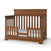 The Child Craft Redmond 4-in-1 Convertible Crib in Coach Cherry features a high back panel, slatted sides, an open front with a low safety rail, and includes a white mattress. Shown on a white background.