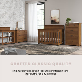 A nursery featuring Child Craft's Redmond 4-in-1 Convertible Crib in Coach Cherry, with craftsman-style wooden furniture, set against a white brick wall with a window, art, and plants. Text: Crafted Classic Quality.