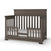 The Child Craft F09514 Toddler Guard Rail in Dapper Grey is shown installed on a brown wooden crib in toddler bed mode, featuring slatted sides, back, and a visible white mattress.