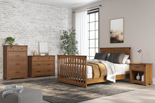 A modern bedroom with light walls, large window, wooden bed—crafted using Child Craft F06424 Full-Size Bed Rails in Coach Cherry—gray and beige bedding, matching nightstand, dresser, chest of drawers, green plant, and framed artwork.