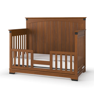 The Child Craft Redmond Full Panel 4-in-1 Convertible Crib in Coach Cherry features a high back, open side slats, low front rail, and elegant finish—perfect for your nursery furniture collection.
