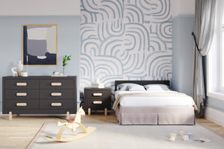 Modern bedroom with light blue walls, abstract wall art, a black bed, a Child Craft Park Heights Night Stand in Caviar Black with light handles, a rocking horse, children's blocks on Brazilian hardwood floors, and a large window with sheer curtains.