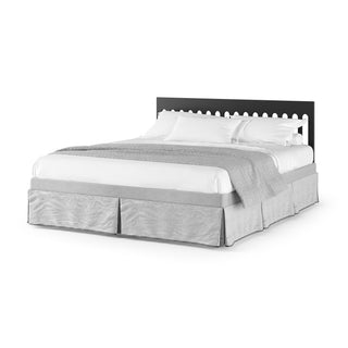 The Park Heights 4-In-1 Euro Crib by Child Craft in caviar black pairs with white bedding and a light gray blanket, evoking timeless artisan charm against a crisp white backdrop.