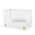 A Child Craft F09505 Toddler Guard Rail in matte white is shown on a plain white background, attached to a white crib with slatted sides and light wooden legs.