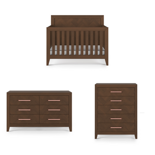 Child Craft's Kieran 4-in-1 Convertible Crib in Toasted Chestnut features a slatted crib with a striped mattress, plus a six-drawer dresser and five-drawer chest, all with metallic handles for a coordinated nursery set.