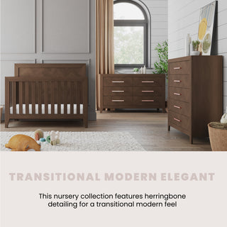 A modern nursery with a wooden crib, changing table, and the Child Craft Kieran 6-Drawer Double Dresser in Toasted Chestnut, all boasting herringbone details. Neutral decor, plush toys, a large window, and wall art add an elegant touch.