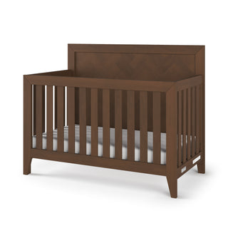 The Child Craft Kieran 4-in-1 Convertible Crib in Toasted Chestnut features a modern, minimalist design with vertical slats, a solid rectangular headboard, and sits on four short legs.